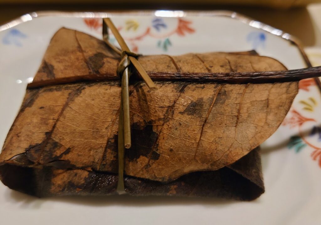 奈良屋の夕食の「鰈（カレイ）の朴葉蒸し」は、大きな葉っぱで包まれている。